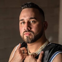 a man with a beard posing with a backpack